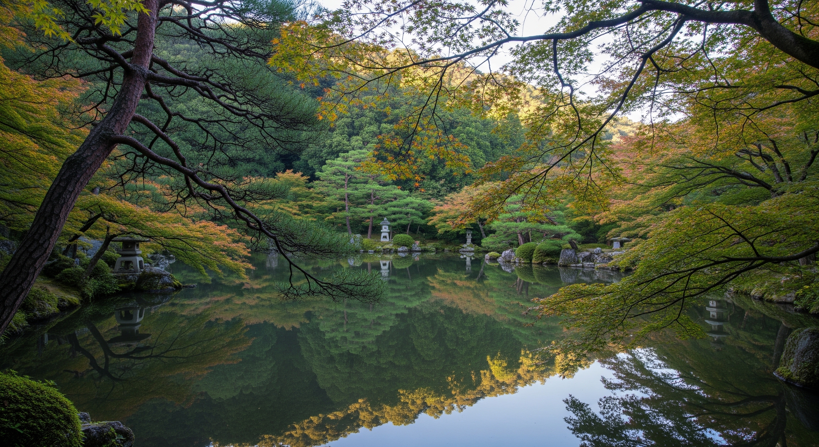 Tenryu-ji garden central pond reflecting the Arashiyama hillside, Japanese maples and pines framing the view