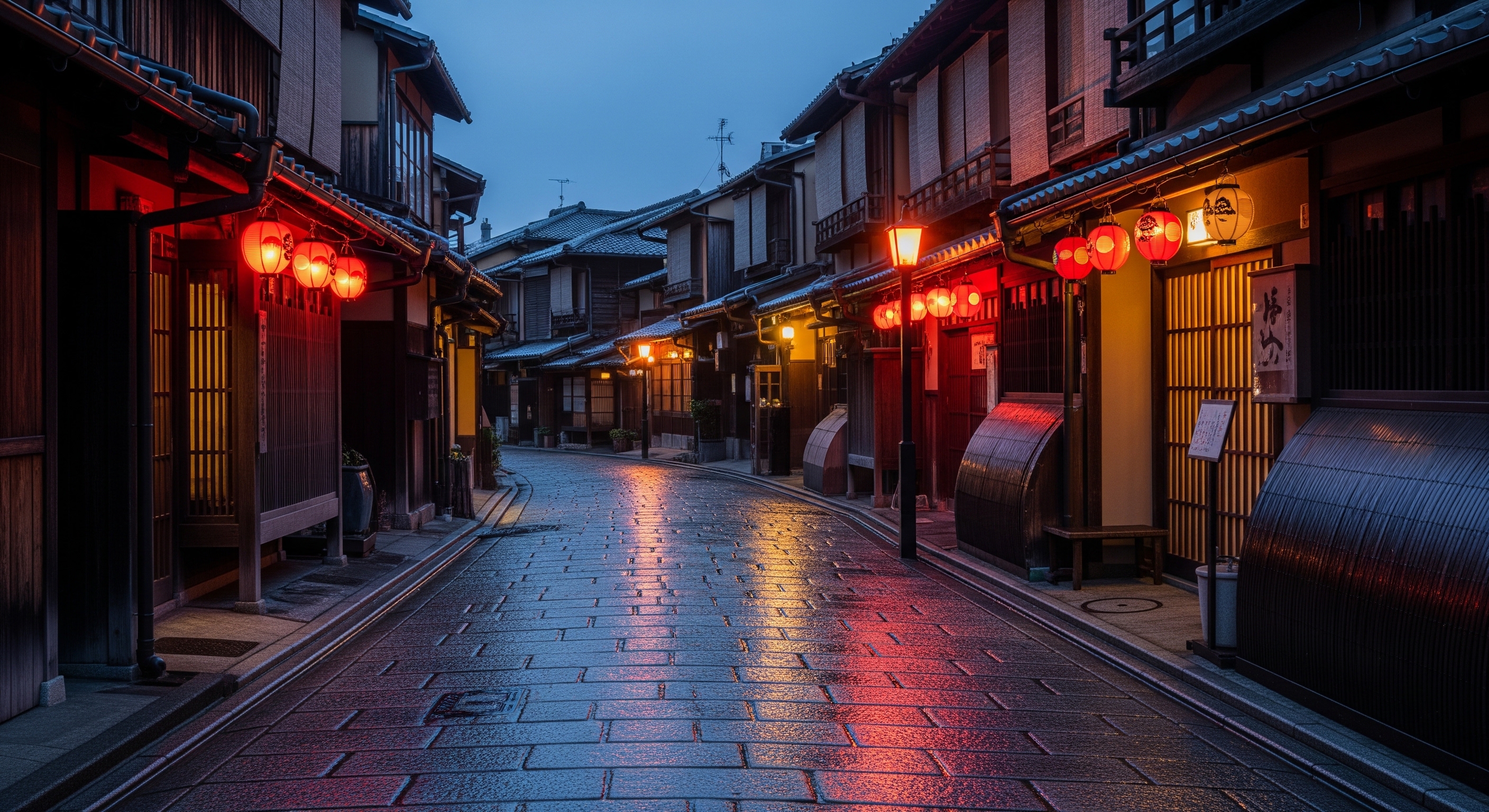 Gion district stone-paved street at dusk, traditional teahouses with glowing red lanterns
