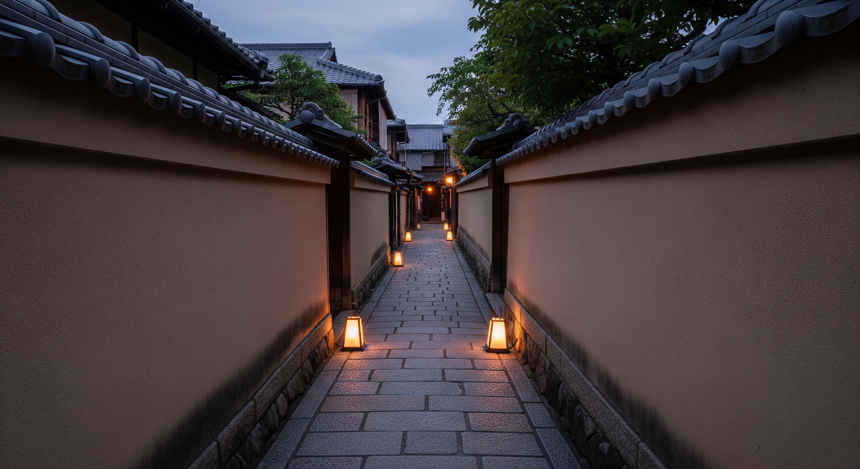 Ishibei-koji hidden stone alley in Higashiyama with high earthen walls and traditional lanterns at dusk